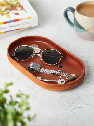 Handcrafted tan leather valet trays in a  pill shape, perfect for organising keys, sunglasses, and everyday essentials. Stylish and practical home accessories