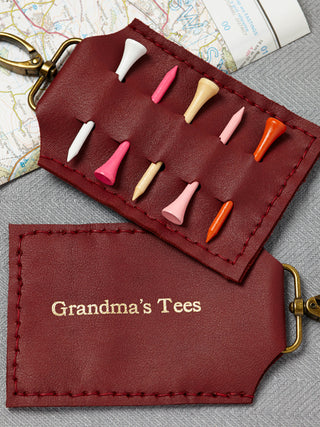 Handmade red leather golf tee holder with brass clip, featuring personalised white text. Holds up to six wooden golf tees—perfect golf gift for him, dad, or grandpa