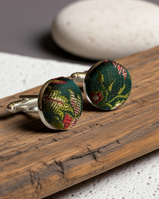 Floral patterned cufflinks on a wooden surface