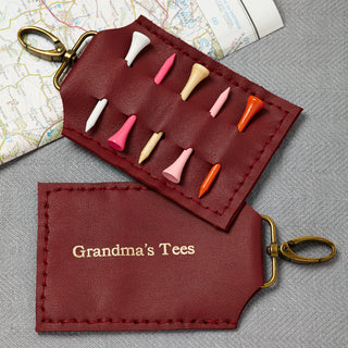 Luxury dark red leather golf tee holder with space for five wooden tees, personalised with gold embossed text. A perfect gift for golf lovers, grandads, and golf enthusiasts. Clip it onto your golf bag