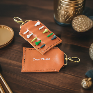 Handmade tan leather golf tee holder with brass clip, featuring personalised white text. Holds up to six wooden golf tees—perfect golf gift for him, dad, or grandpa