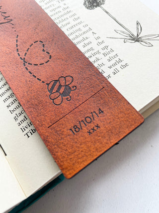 close up of wedding date engraved on to a bookmark.