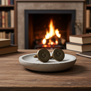 Green Leather Cufflinks on a stone dish with a fireplace and books in the background