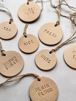 Handmade round leather label with "MILK" embossed, attached to a glass bottle with jute string. Ideal for rustic kitchen styling, pantry storage, or customisable home organisation