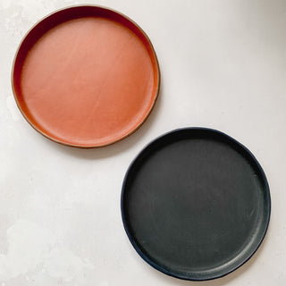 Cognac and midnight blue circular leather tray.