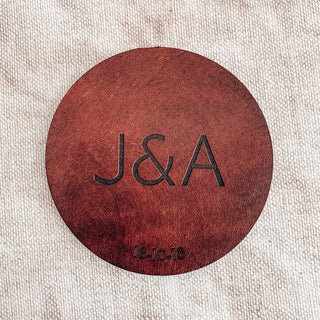 Block font laser engraved leather coasters, perfect anniversary gift.